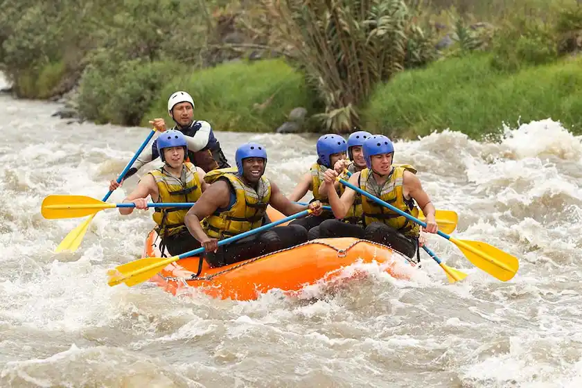 A group of young people having fun while water rafting