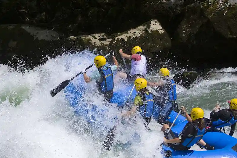 A group of young people having fun while water rafting