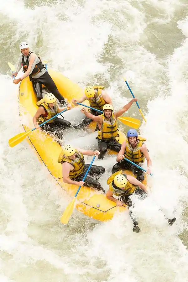 A group of men water rafting